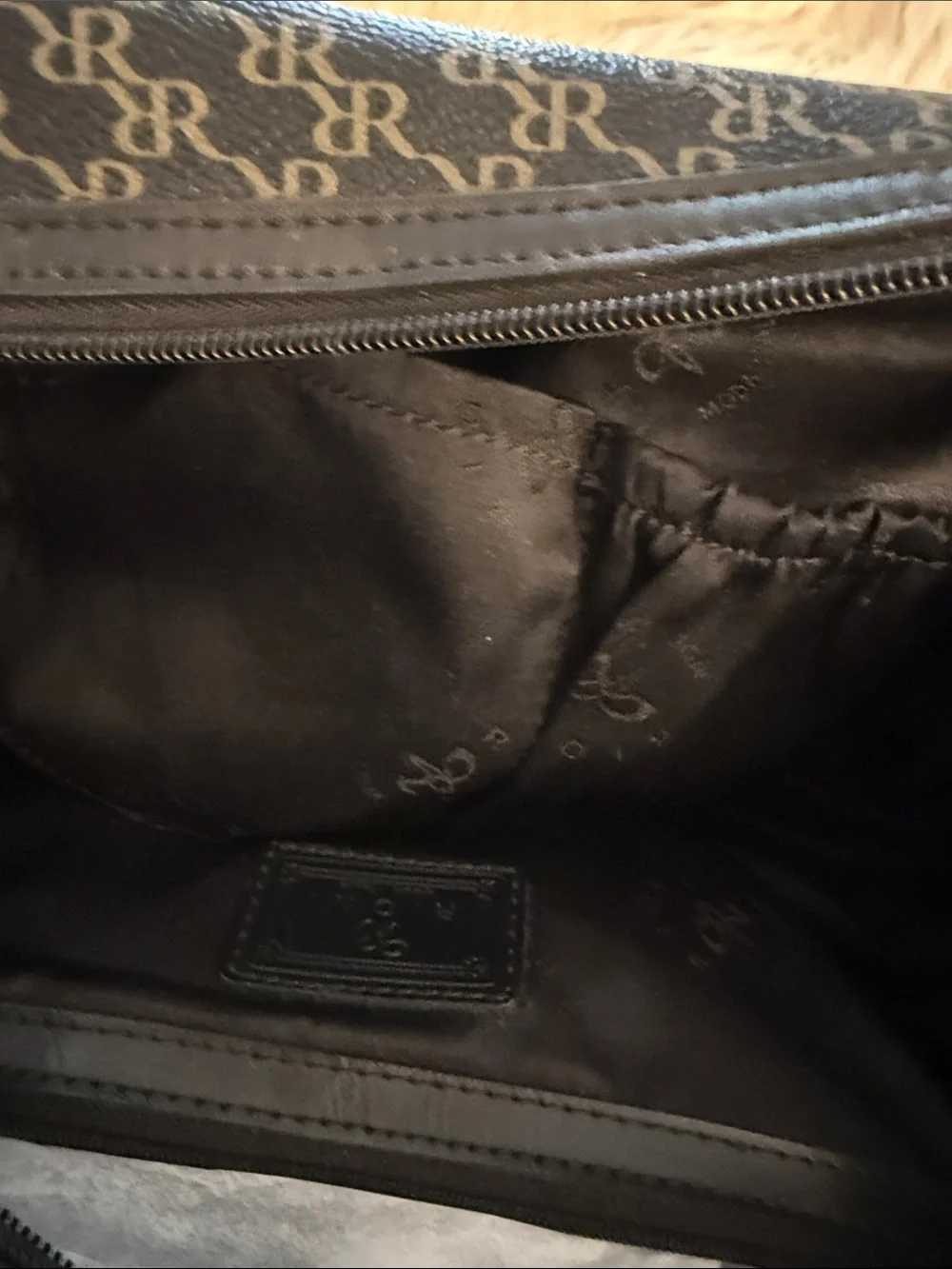 Rioni Signature Organizer Satchel featuring a black monogram 
